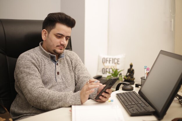 Young businessman doing his work at Office. Professional portrait of a businessman sitting on chair