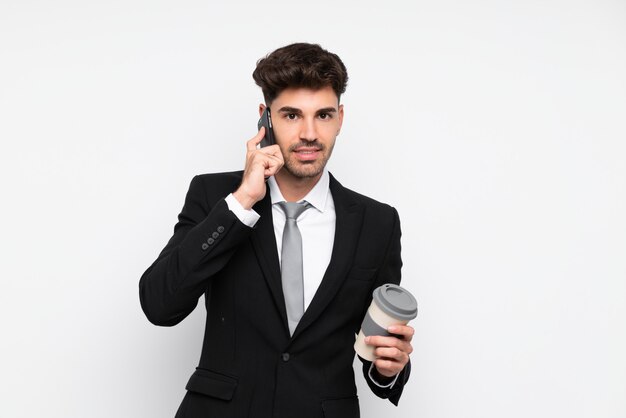 Young businessman holding coffee to take away over isolated white 