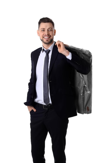 Young businessman holding hanger with jacket in plastic bag on white background Drycleaning service