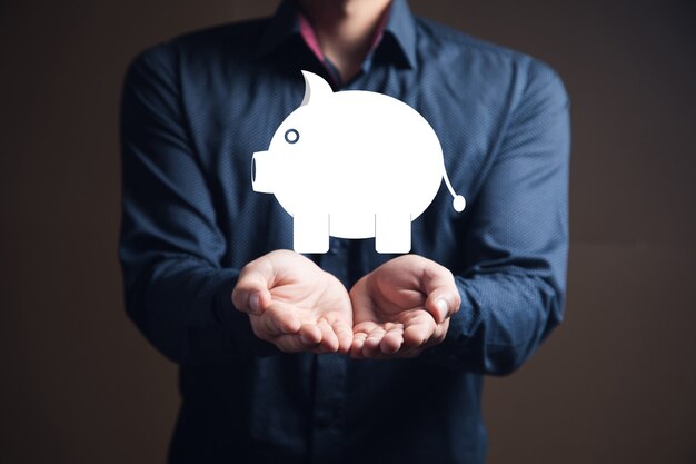 Young businessman holding pig icon