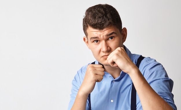 Young businessman instructs with fists