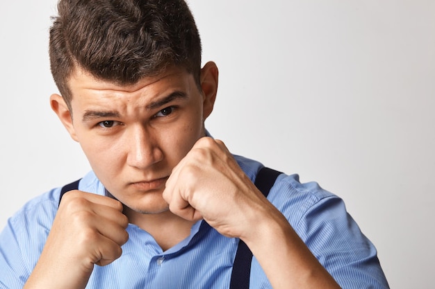 Young businessman instructs with fists