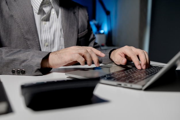 A young businessman is using a laptop to search for important information on business competitors A laptop was used to access important documents by one employee