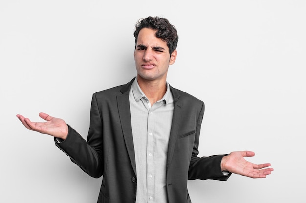 Young businessman looking puzzled, confused and stressed, wondering between different options, feeling uncertain