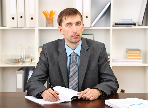 Young businessman in office at his workplace