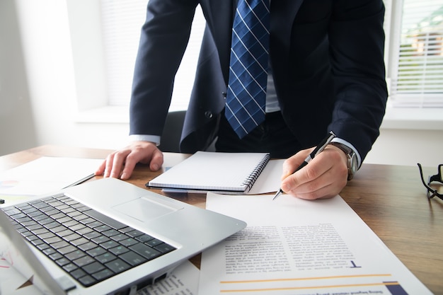 Young businessman in office with smartphone tablet at workplace