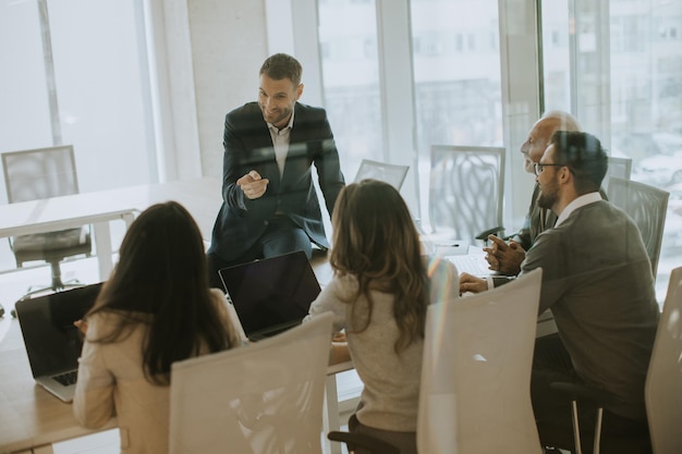 Young businessman presenting results to his coleagues in the office