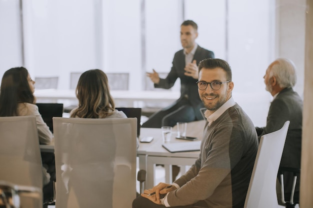 Young businessman presenting results to his coleagues in the office