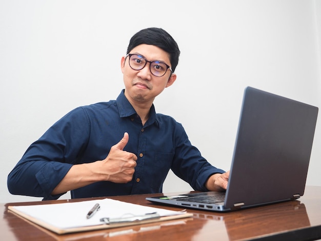 Young businessman show thumb up about success working