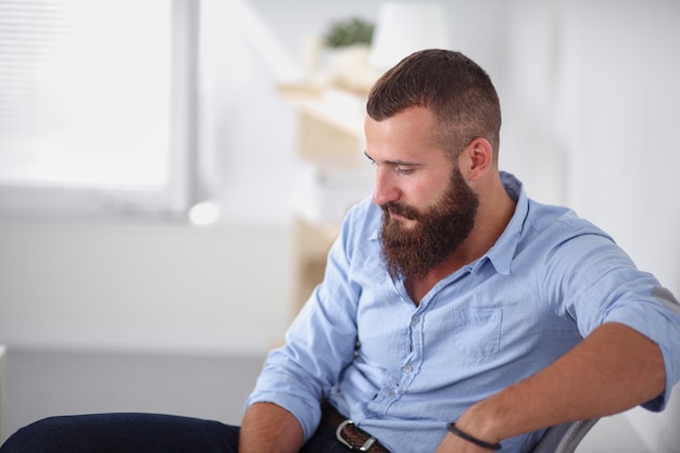 Young businessman sitting on chair in office