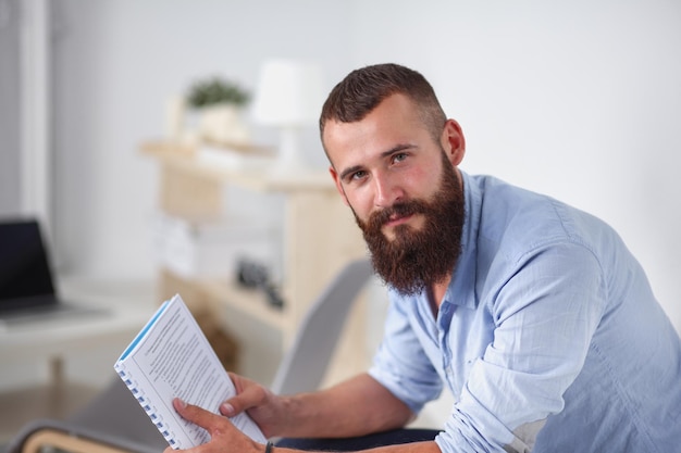 Young businessman sitting on chair in office