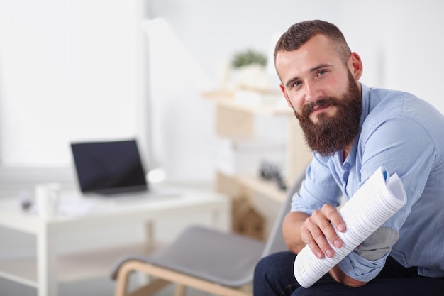 Young businessman sitting on chair in office