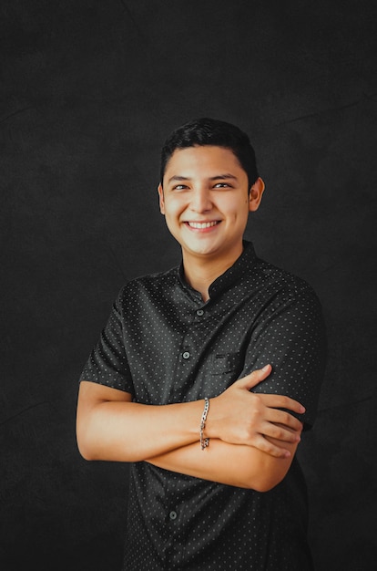 young businessman smiling on a black background