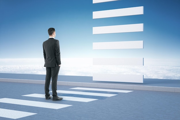 Young businessman in suit standing on crosswalk