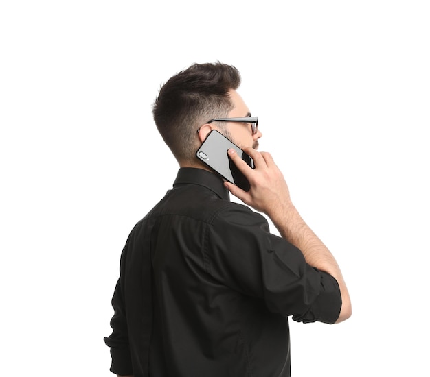 Young businessman talking on smartphone against white background