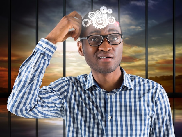 Young businessman thinking scratching head against room with large window looking on landscape