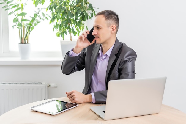 Young businessman using his laptop, close up.