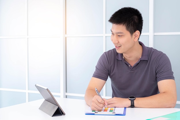 Young businessman using a laptop analyze business data at the office