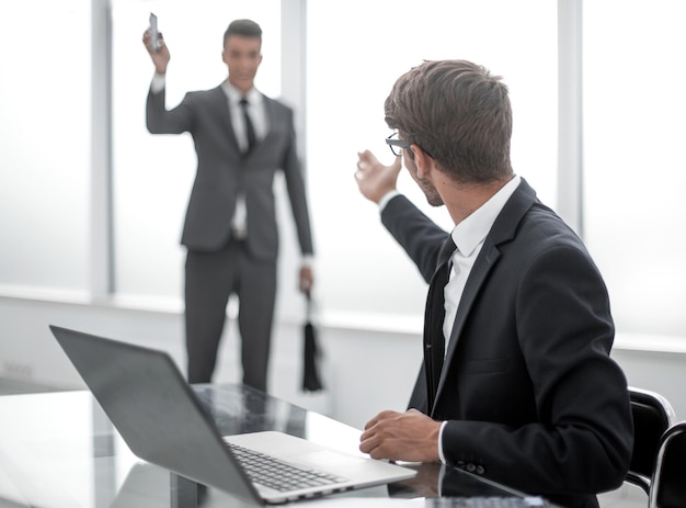 Young businessman welcome his colleague who was long absent from the workplace