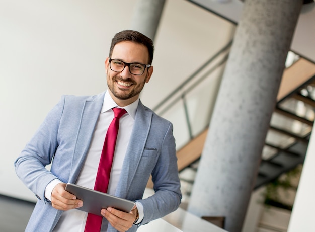 Young businessman with digital tablet in office