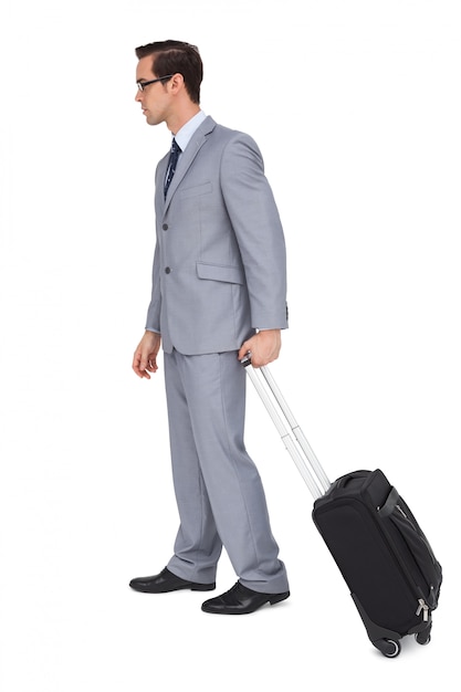 Young businessman with glasses holding a trolley