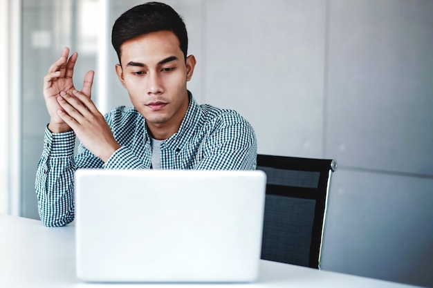 Young Businessman Working on Computer Laptop in Office.