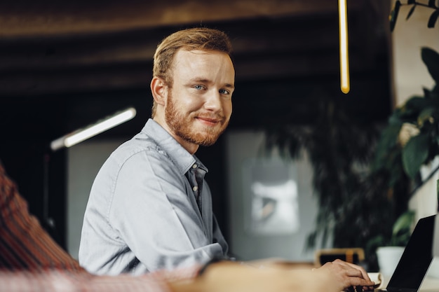 Young businessman working on computer in the office