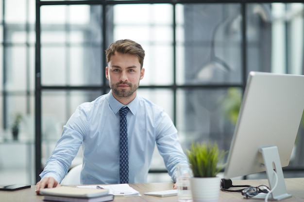 Young businessman working at modern glass office