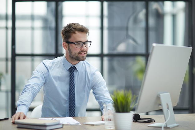 Young businessman working at modern glass office