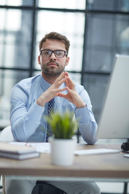 Young businessman working at modern glass office