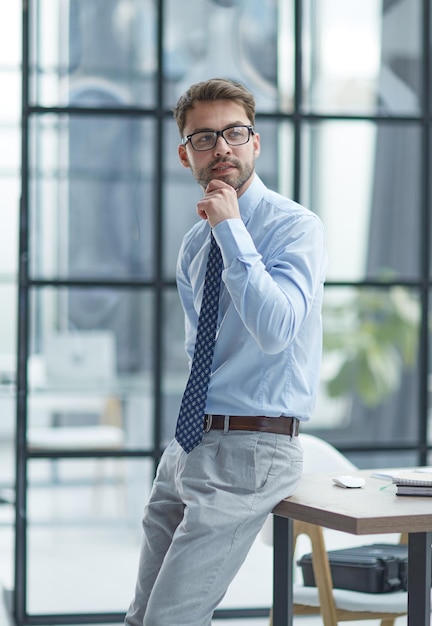 Young businessman working at modern glass office