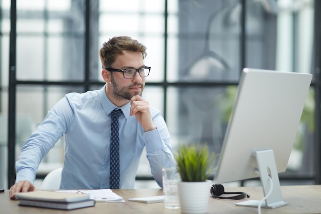 Young businessman working at modern light office