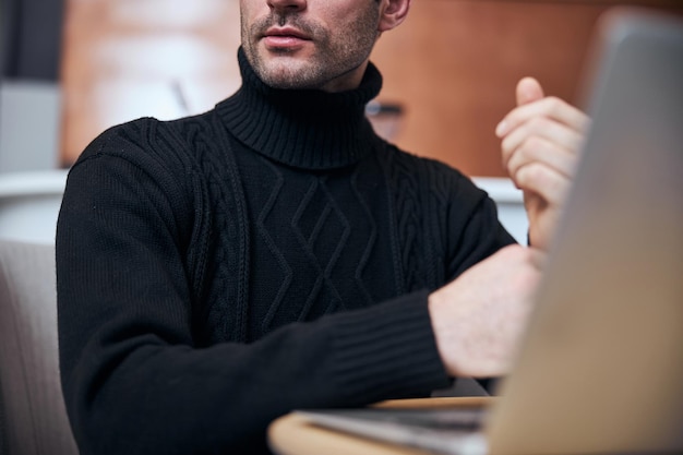 Young businessman working on notebook in lobby