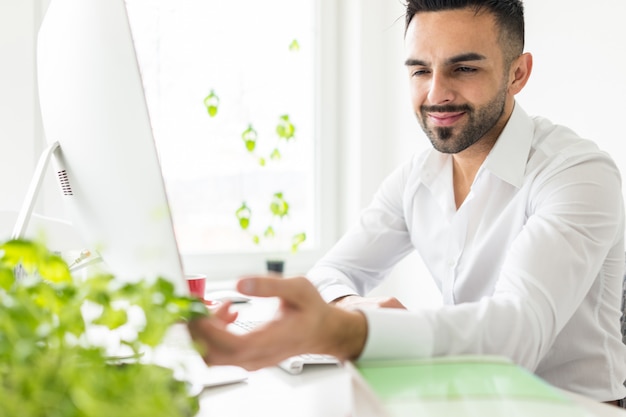 Young businessman working at office on computer desk