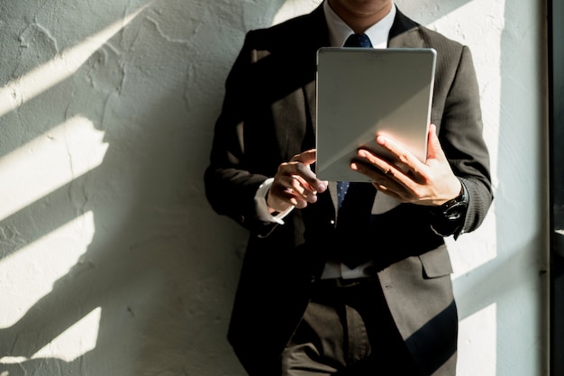 Young businessman working with mobile laptop and documentsin office, business concept