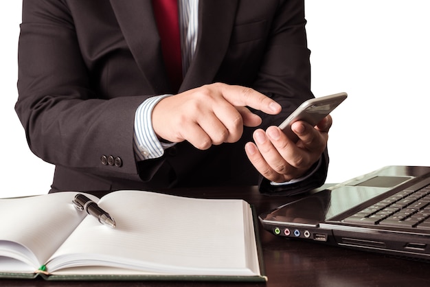 Young businessman working with modern devices, smartphone and laptop computer