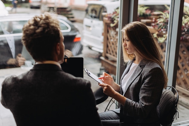 Young businessmen having a meeting in a cafe