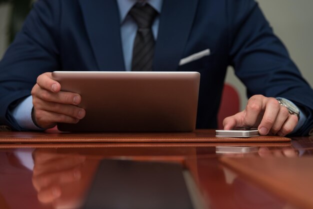 Young Businessmen Using Touchpad At Meeting