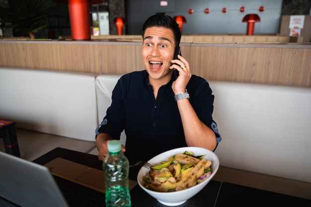 Young businessperson have a phone call during lunch break Male with Surprised and amazed expression