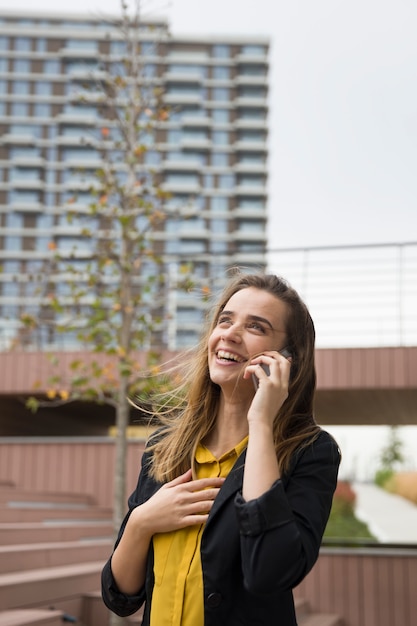 Young businesswman using mobile phone outdoor