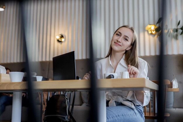 Young businesswoman on a coffee break Using tablet computer