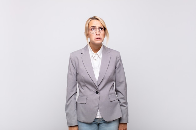 Young businesswoman feeling sad and whiney with an unhappy look, crying with a negative and frustrated attitude