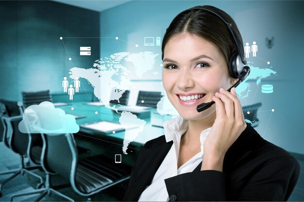 Young businesswoman in headset smiling at camera