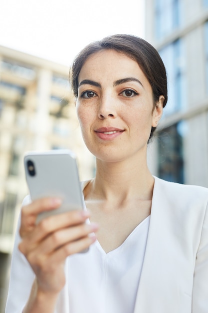 Young Businesswoman Holding Smartphone