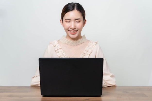 A young businesswoman is very happy after checking her email through her laptop