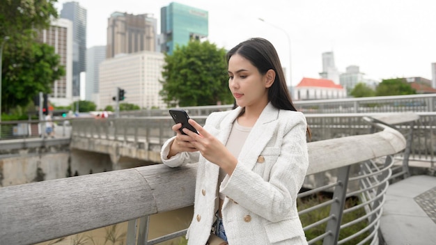 A young businesswoman is working in modern city downtown of Singapore