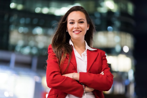 Young businesswoman portrait in a modern city setting at night