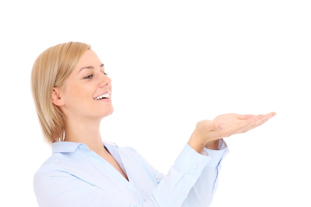 a young businesswoman showing your product on her hand over white background