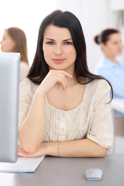 Young businesswoman sitting at desk and working.