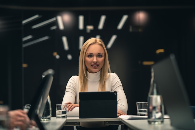 The young businesswoman sitting at the table on business conference